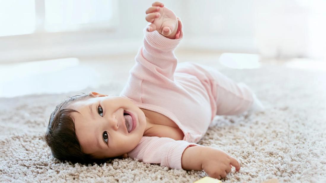 Happy baby in process of rolling over