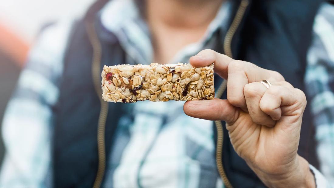 Person holding up a granola bar