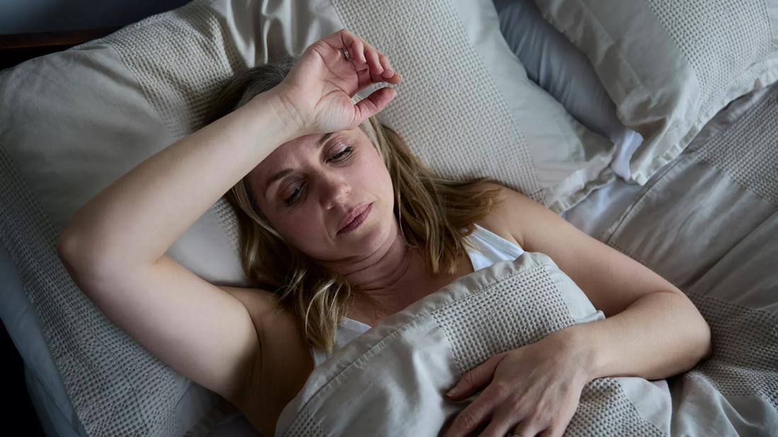 Female awake in bed at night
