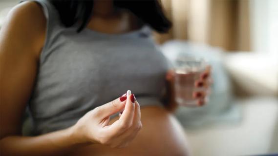 Pregnant woman taking pills