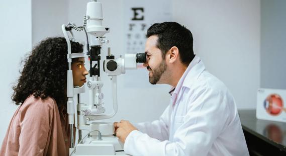 Eye care provider examining patient's eye