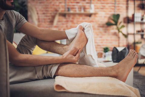 Person drying off feet with towel